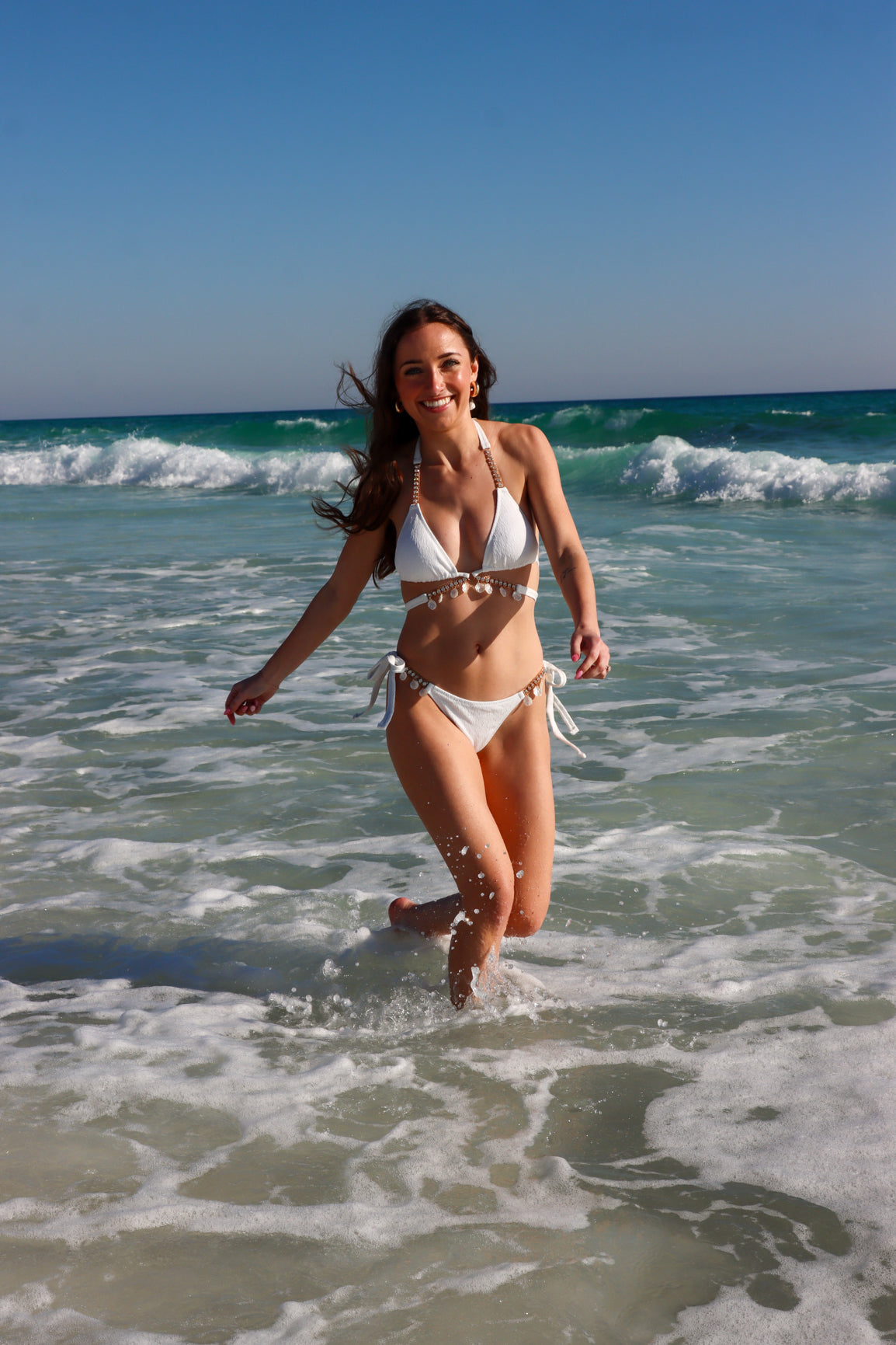 girl wearing white bikini with shell detailing