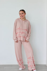 girl wearing tan candy cane heart pajamas