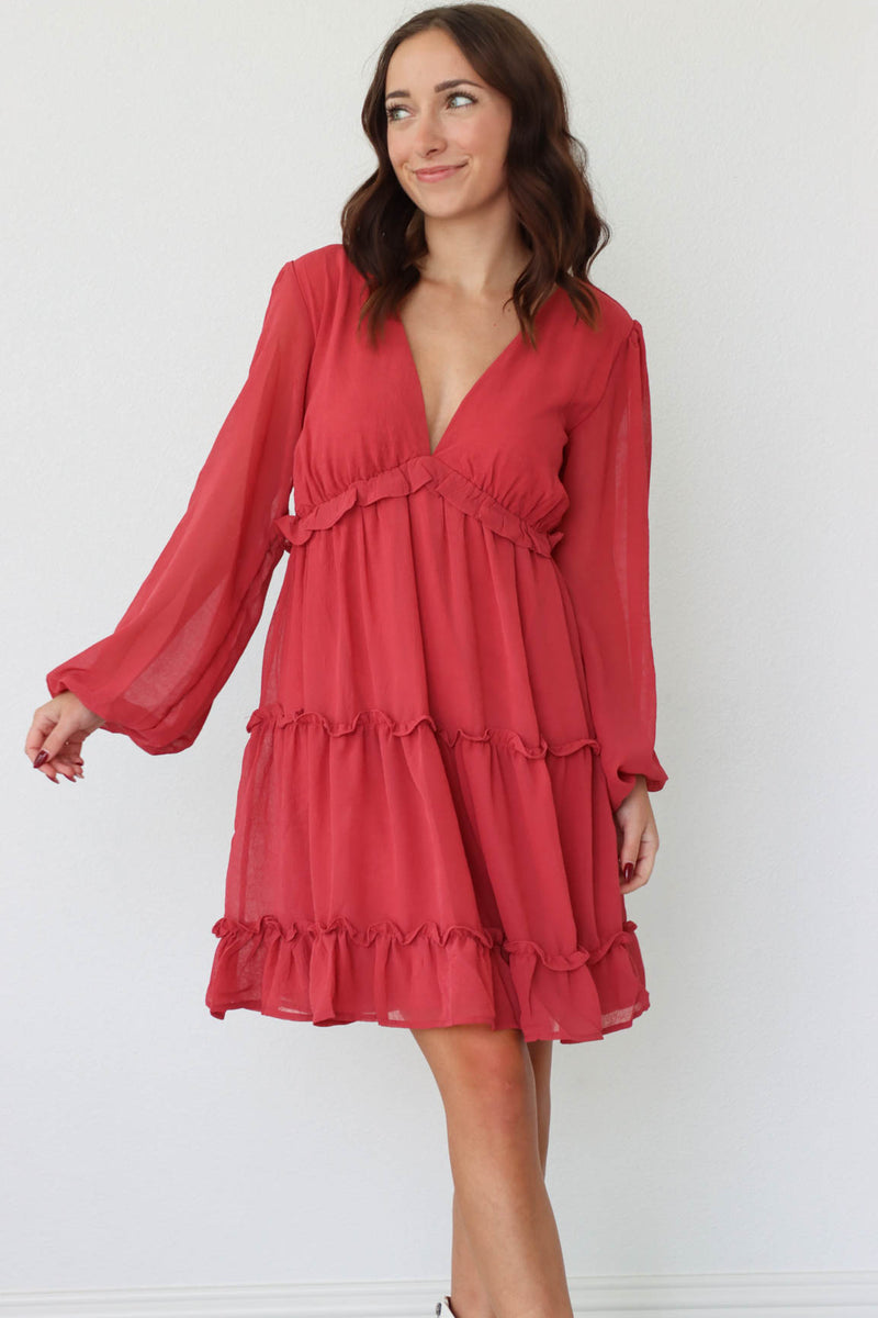 girl wearing red long sleeved flowy short dress