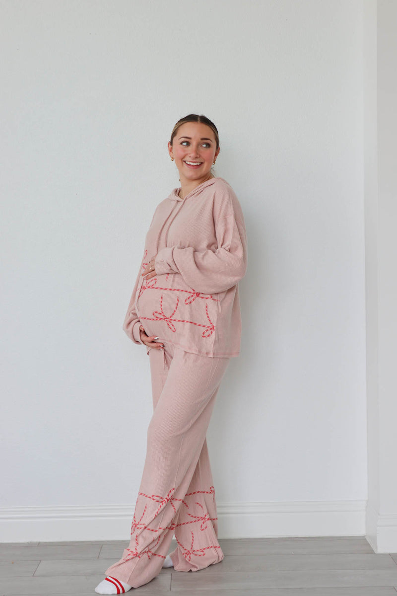 girl wearing tan candy cane heart pajamas