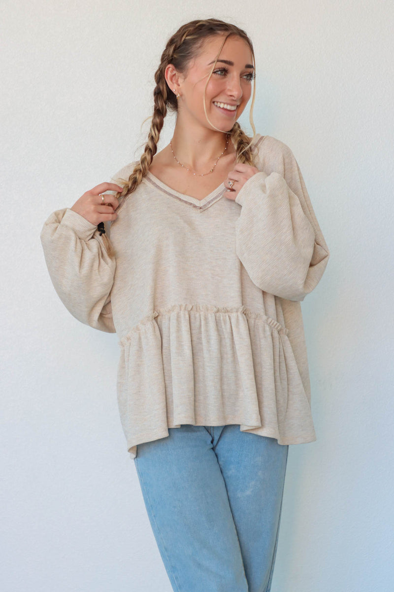 girl wearing cream waffle knit long sleeve top
