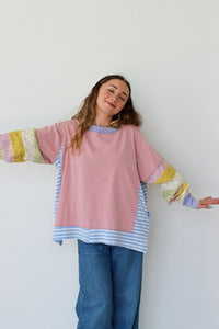Person wearing a colorful shirt with a white background