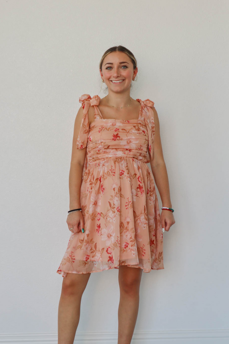 girl wearing peach floral dress