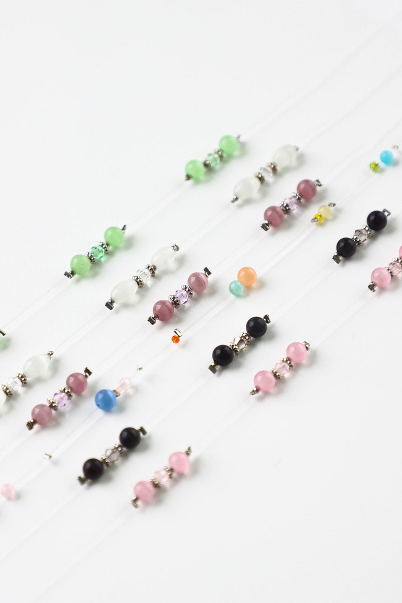 Colorful beaded hair accessories on a white background