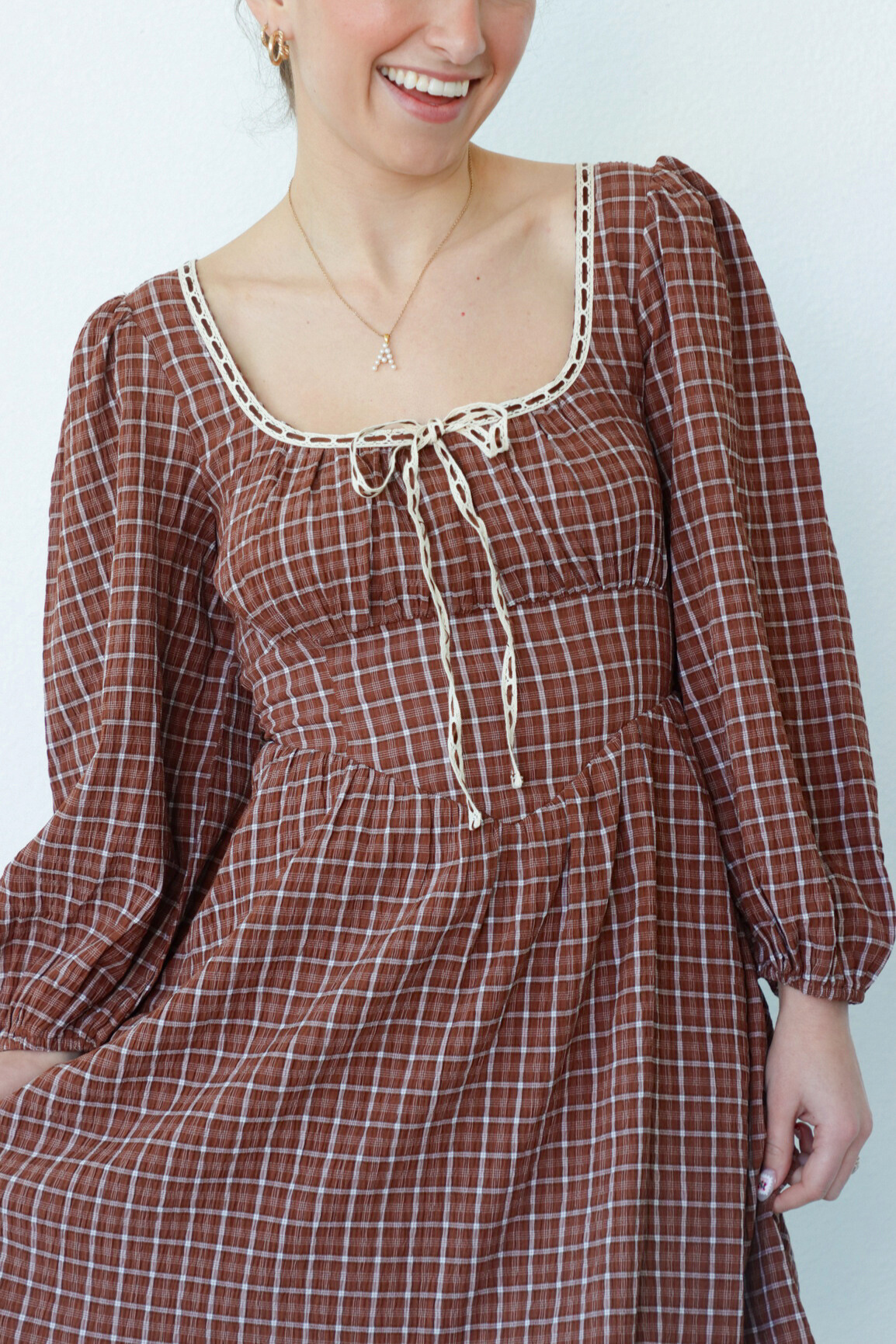 girl wearing brown peasant style dress