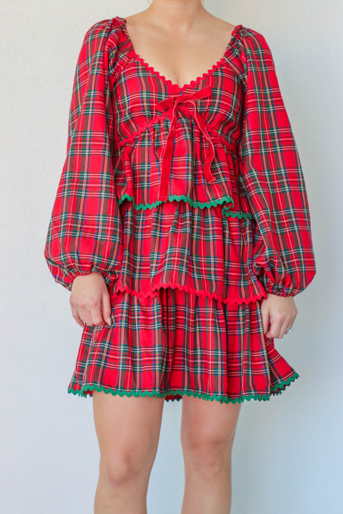 girl wearing red plaid holiday dress