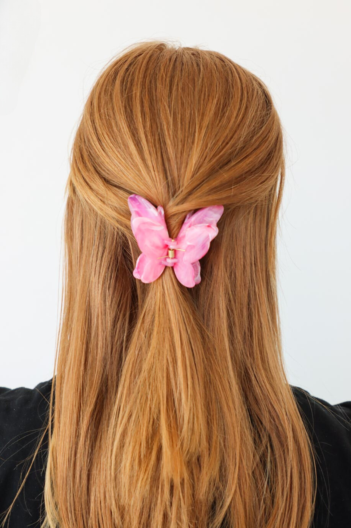 girl wearing pink butterfly hair clip