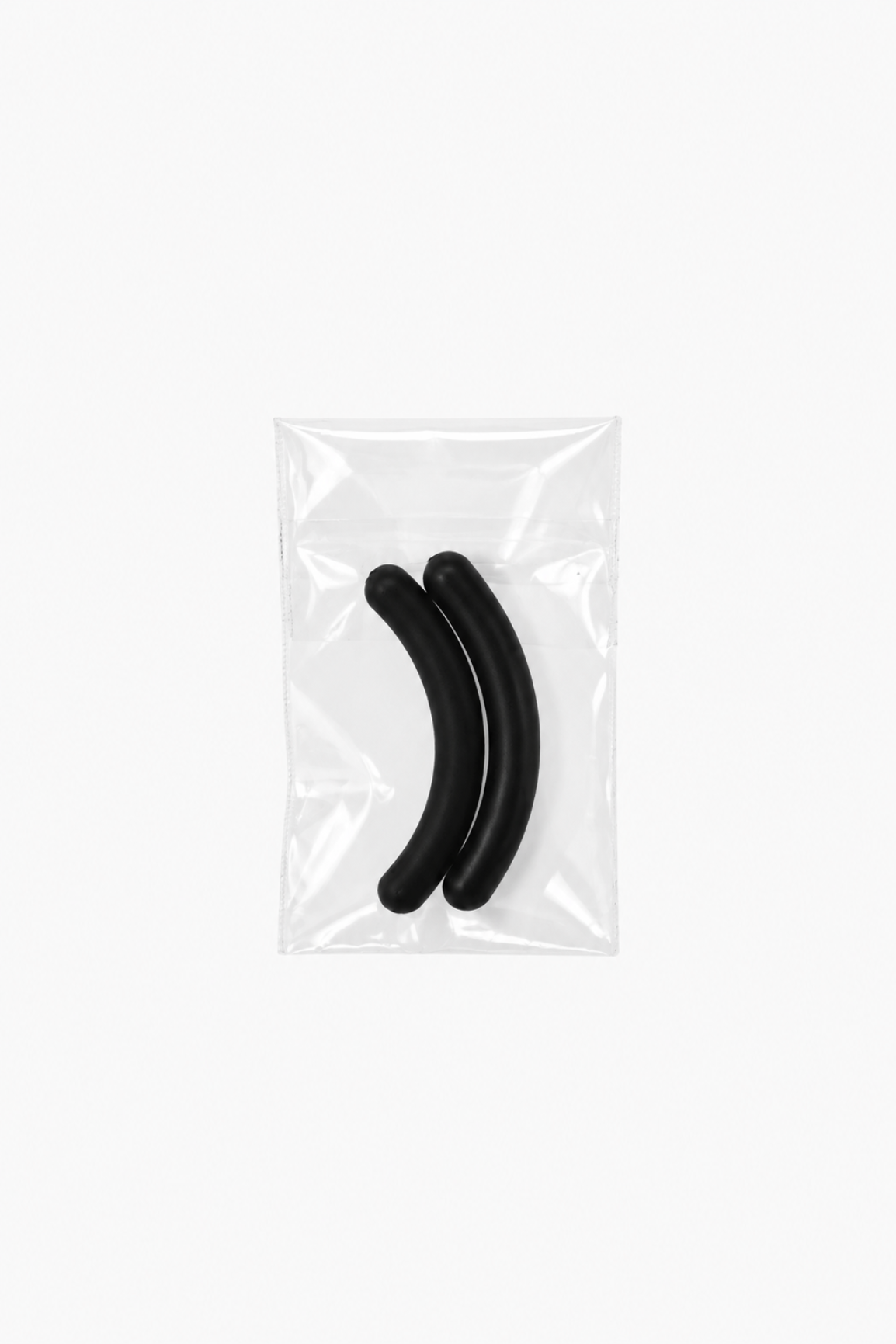 Two black curved silicone earbud tips inside a clear plastic bag, shown on a plain white background.