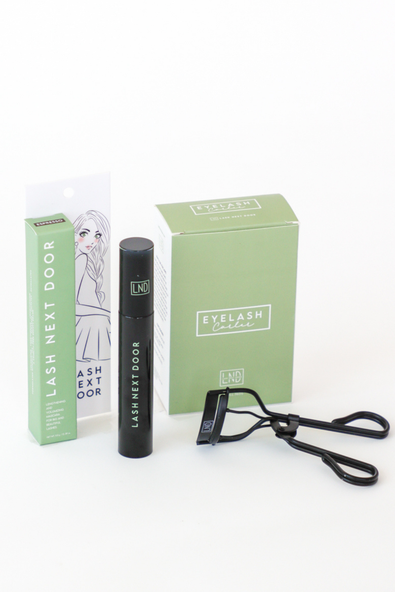 Eyelash extension kit with mascara, applicator, and packaging on a white background