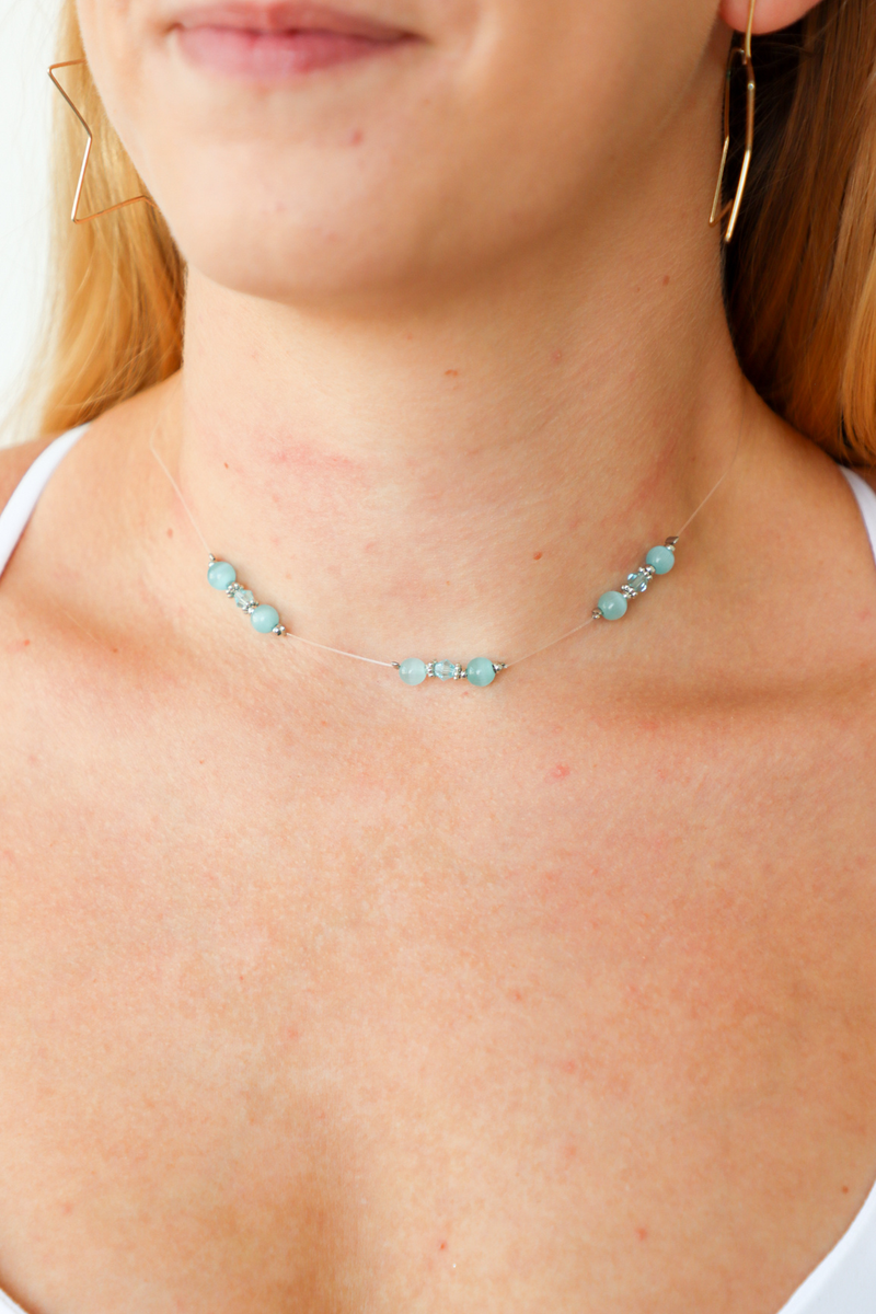 Necklace with turquoise beads worn by a person