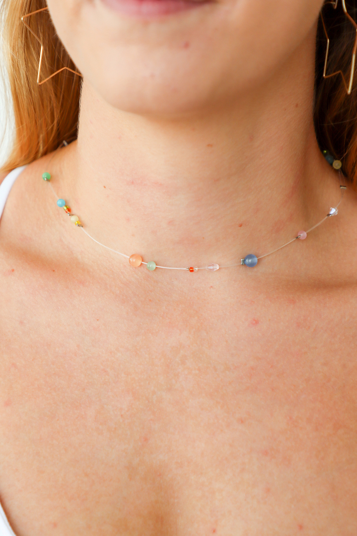 Close-up of a person wearing a colorful beaded necklace.