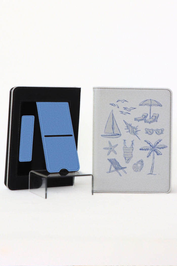 Black stand with blue card and white card with beach illustrations on a white background