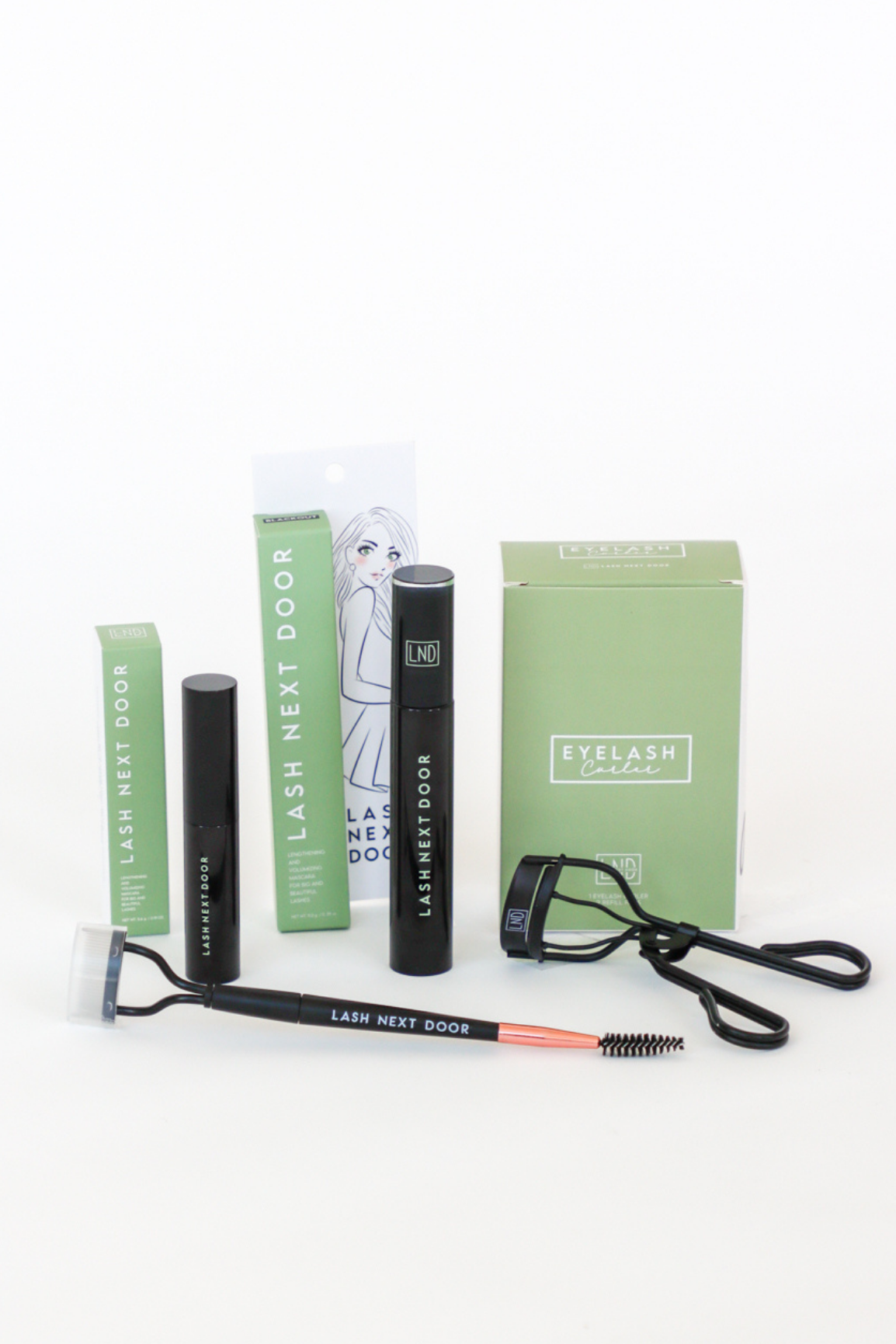 Eyelash extension kit with tools and packaging on a white background