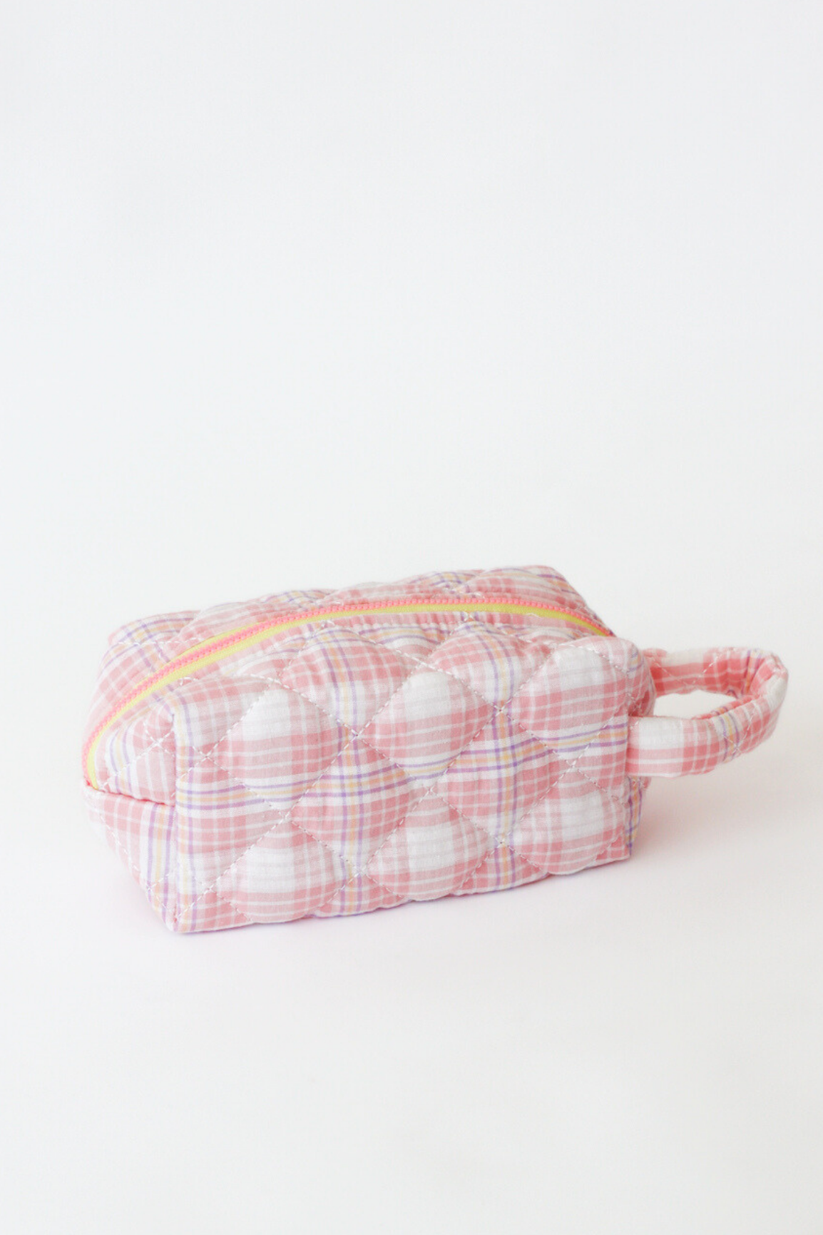 Small pink and white checkered pouch with a yellow zipper on a light gray background