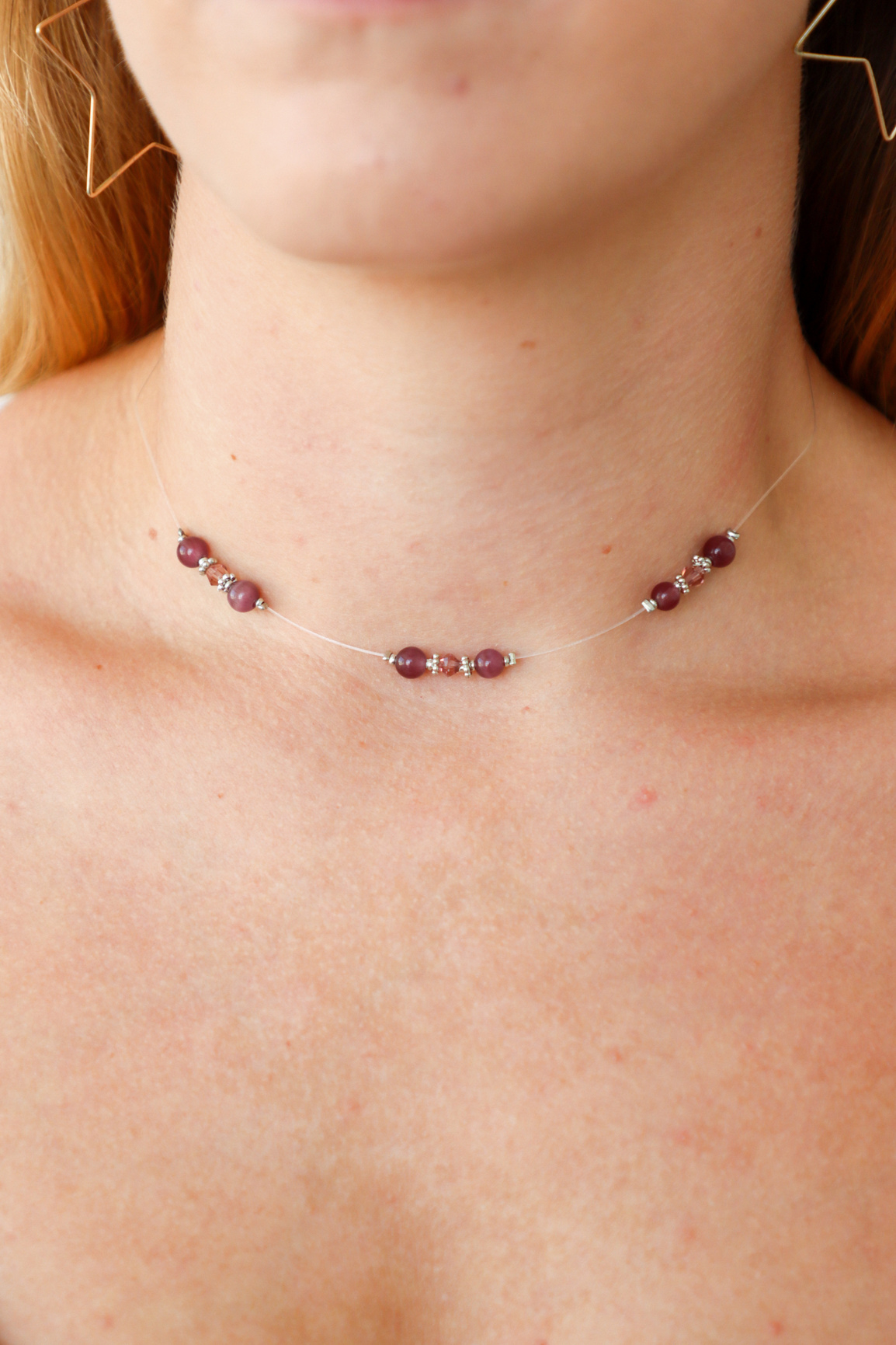 Necklace with small beads worn by a person