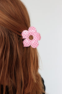 girl wearing pink checkered flower clip in her hair