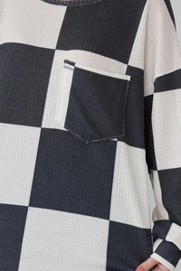 the functional pocket on a black and white checkered longsleeved top