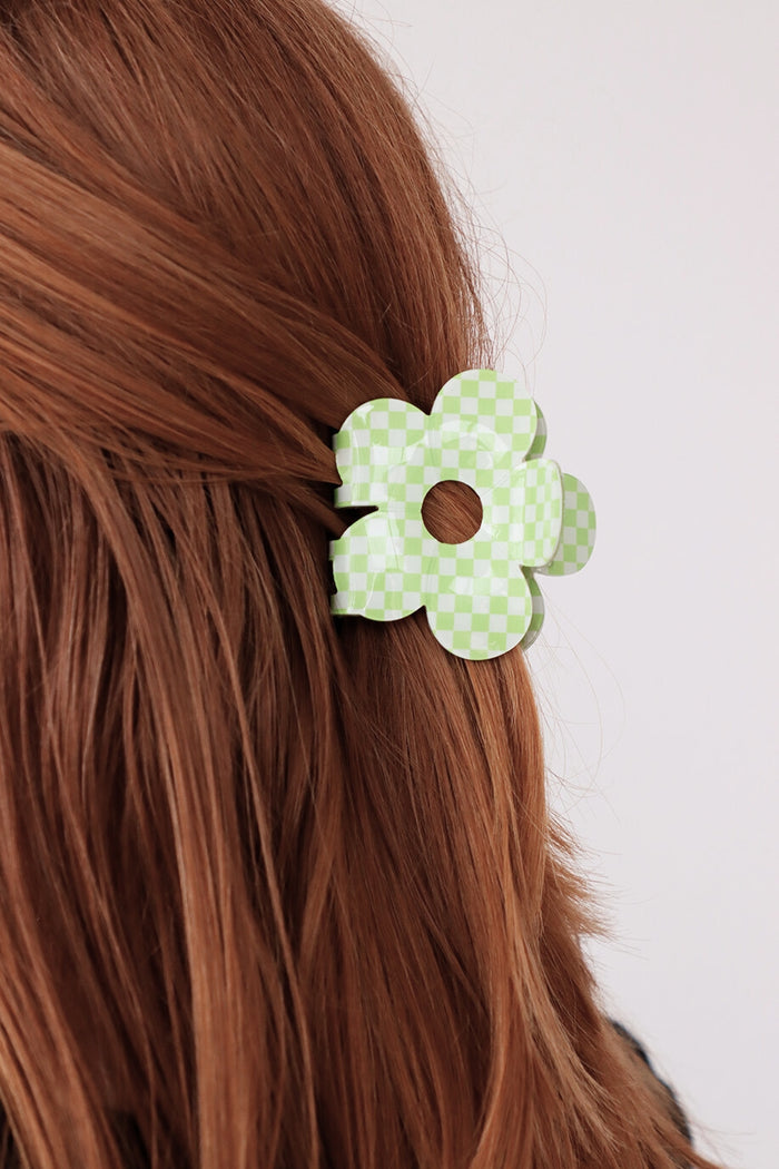 girl wearing green checkered flower clip in her hair