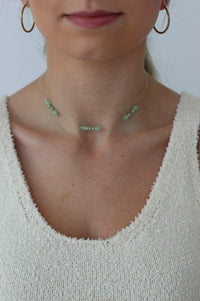 girl poses with a green beaded choker on