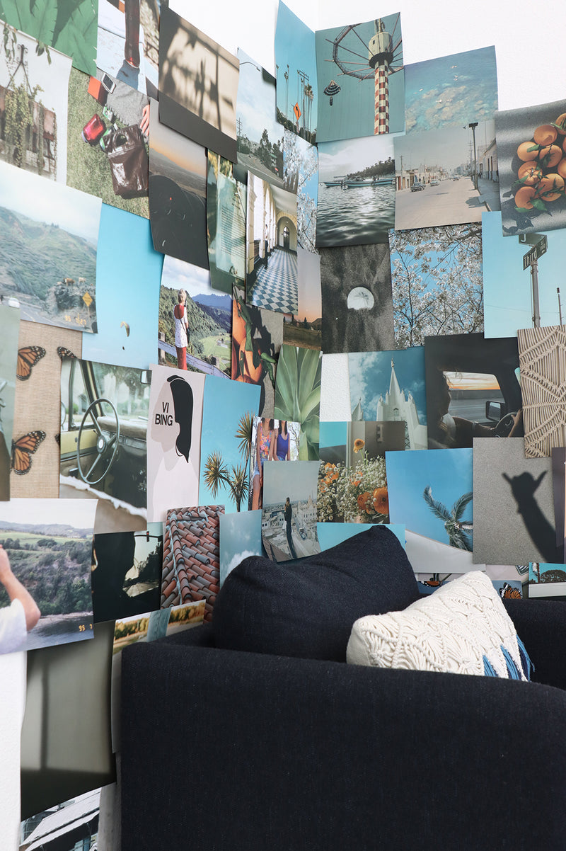 Wall with multicolor photos and graphic design prints in blue teal and green hues themed around california