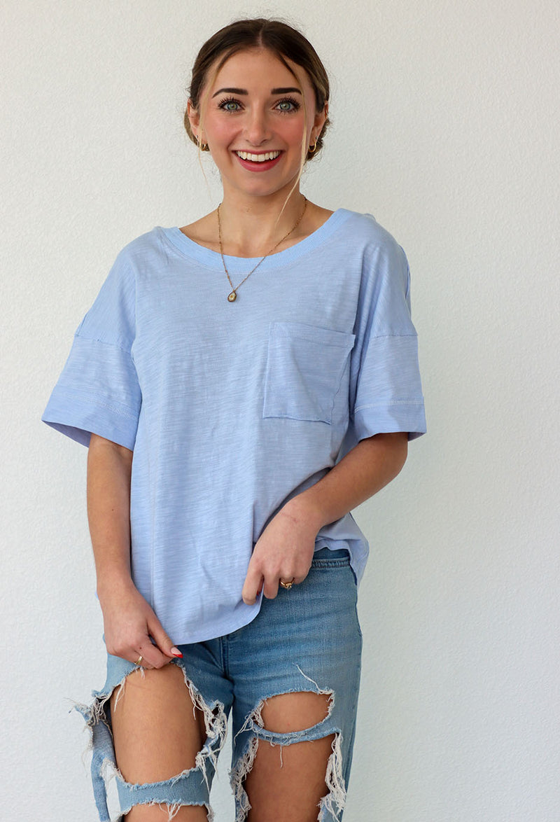girl wearing a blue boxy t-shirt
