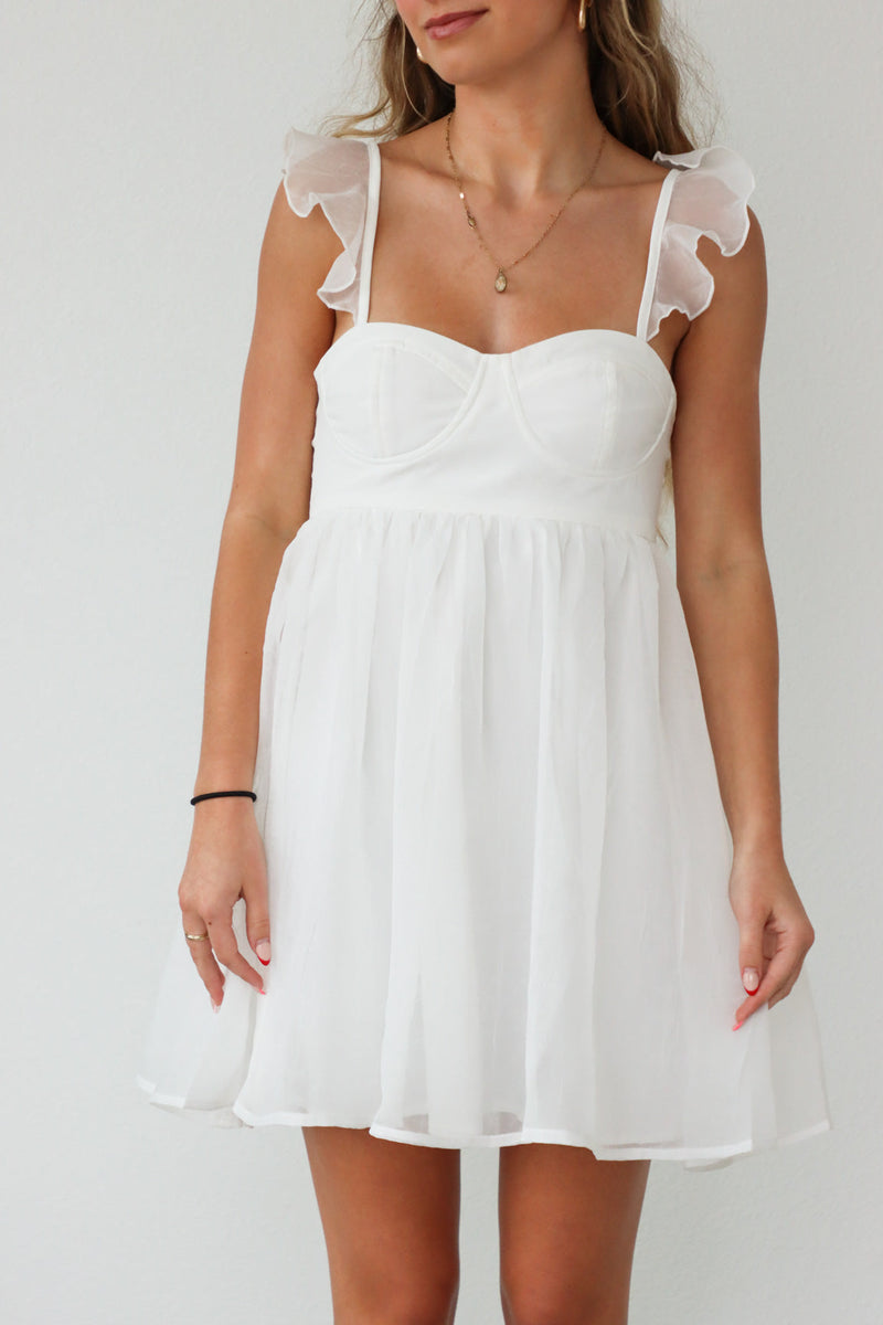 girl wearing short white dress