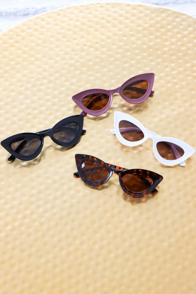 black, purple, white, and brown tortoise cat-eye sunglasses