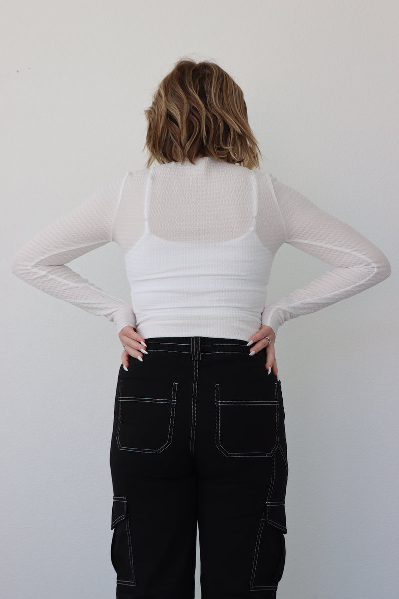 back of the sheer white long sleeve top