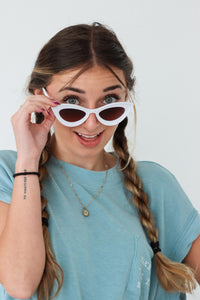 girl wearing white cat-eye sunglasses