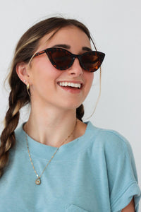 girl wearing brown tortoise cat-eye sunglasses