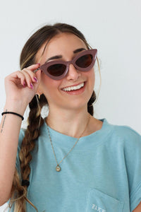 girl wearing purple cat-eye sunglasses