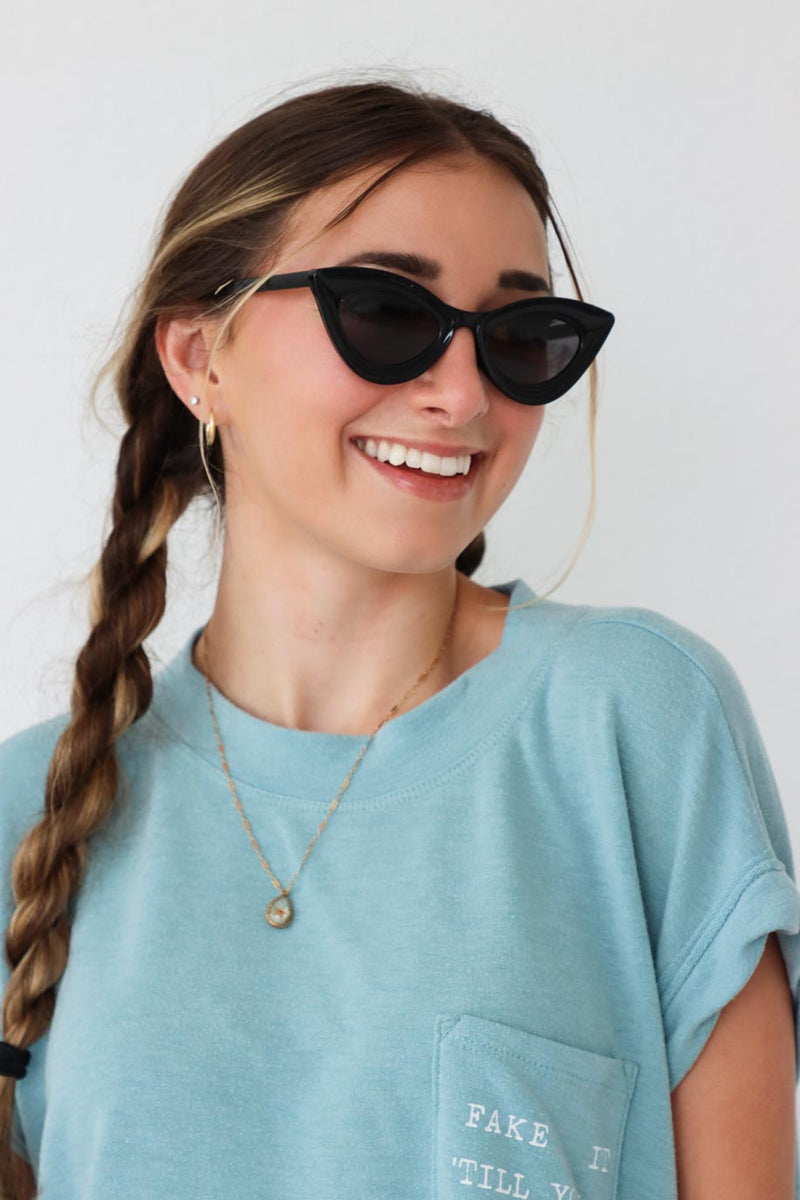 girl wearing black cat-eye sunglasses