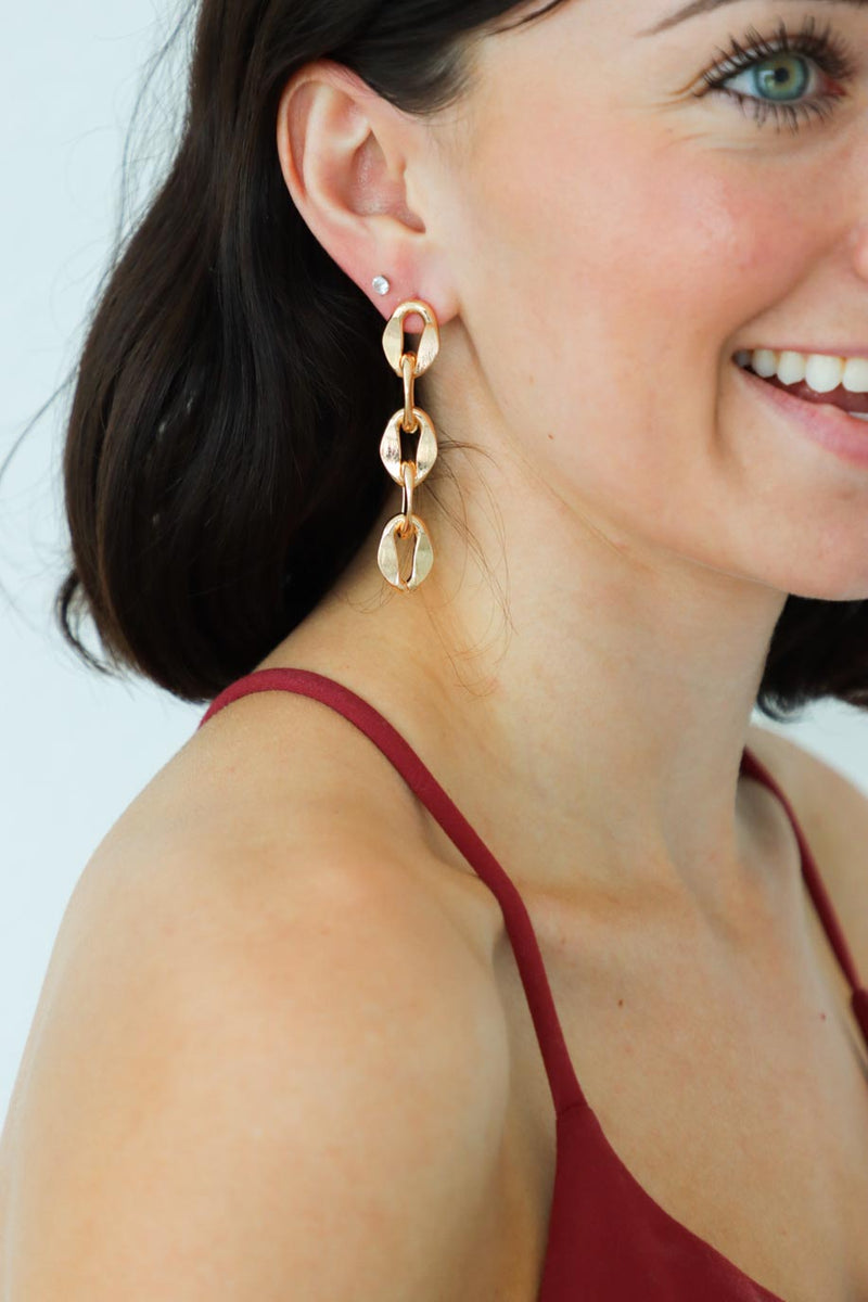 girl wearing gold chain earrings