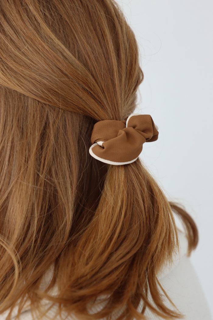girl wearing tan scrunchie in her hair