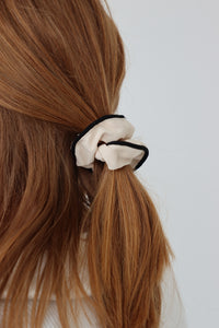 girl wearing white scrunchie in her hair