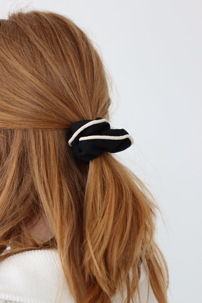 girl wearing black scrunchie in her hair