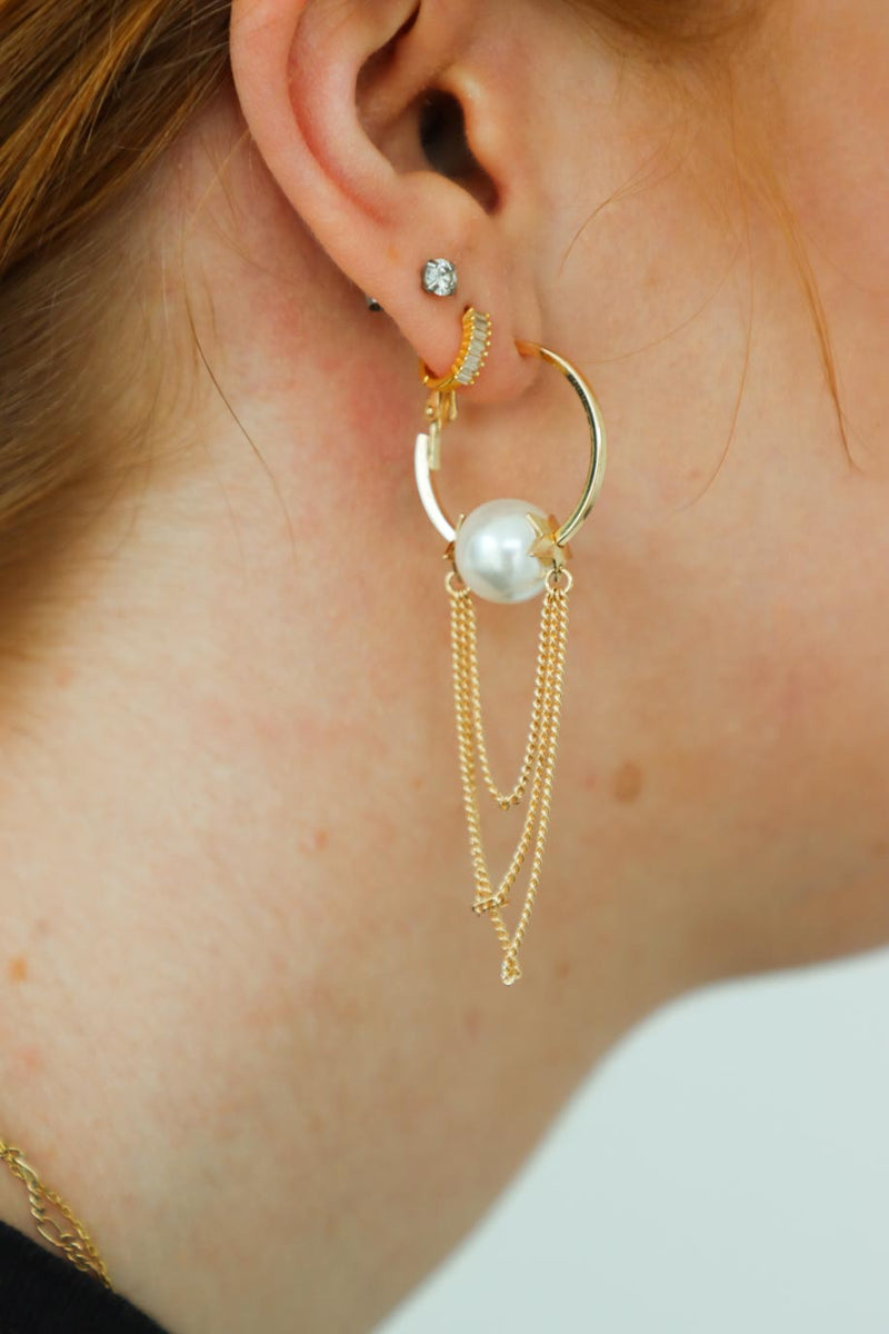 girl wearing gold earrings with pearl detailing