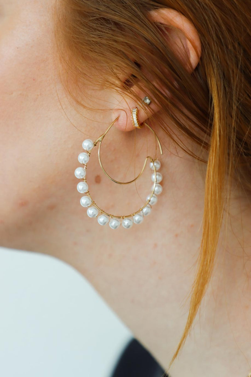 girl wearing gold moon earrings with pearl detailing
