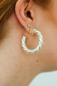 girl wearing silver hoop earrings