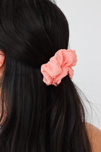 girl wearing orange scrunchie in her hair