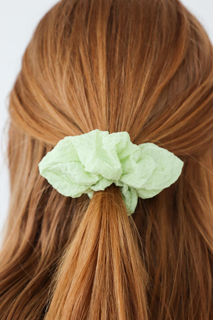 girl wearing green scrunchie in her hair