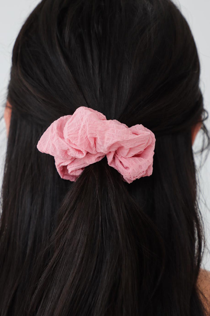 girl wearing pink scrunchie in her hair