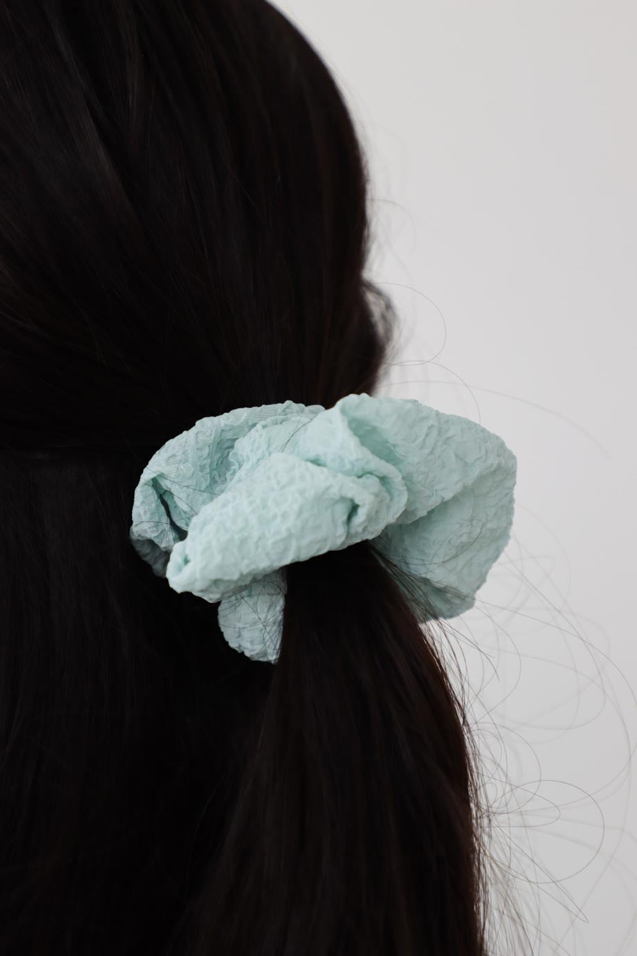 girl wearing blue scrunchie in her hair