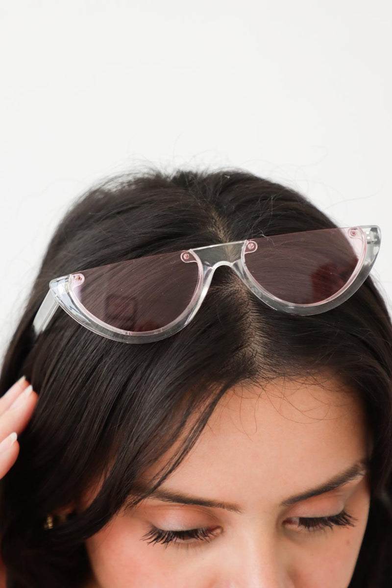 girl wearing pink acrylic sunglasses on her head