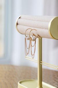 gold earrings with pearl detailing
