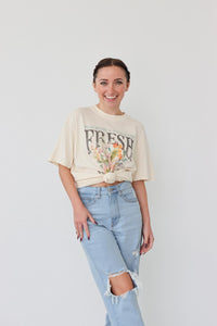 girl wearing cream "fresh flowers" graphic t-shirt