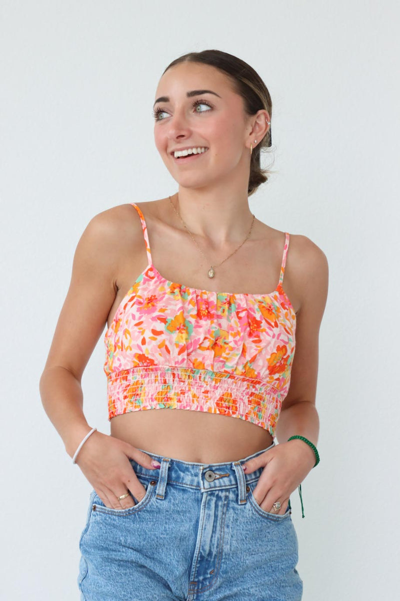 girl wearing pink multicolored floral cropped tank top