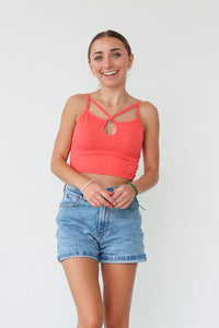 girl wearing coral cropped tank top 