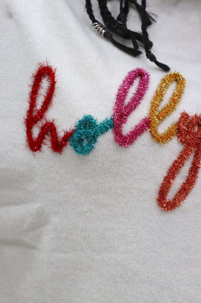 close up of the word "Holly" in multicolor shimmer tinsel