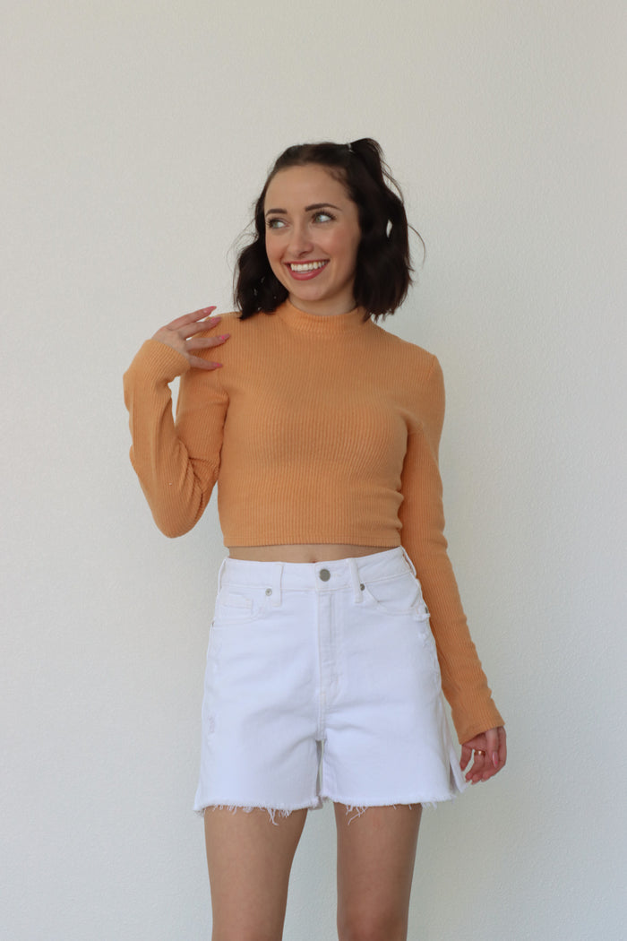 girl wearing orange long-sleeved top